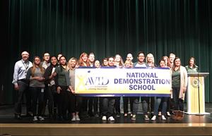 students hold AVID banner 