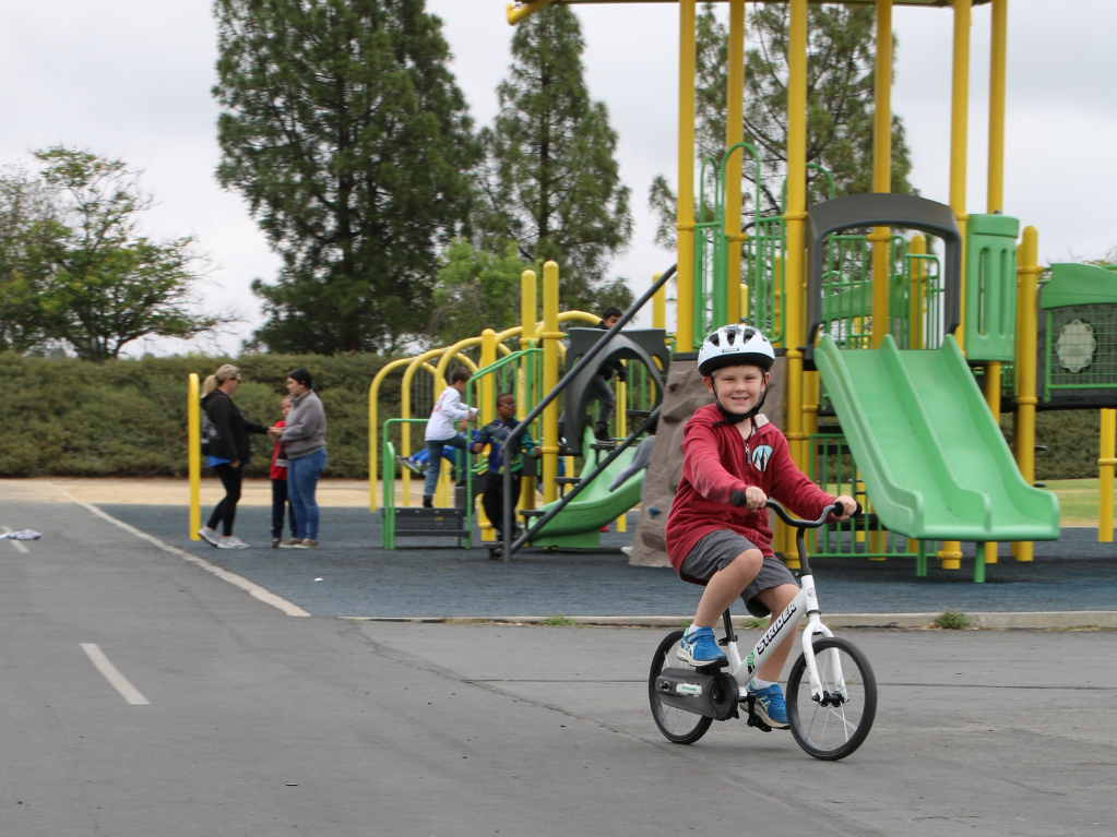 Kindergarten student riding bike to school